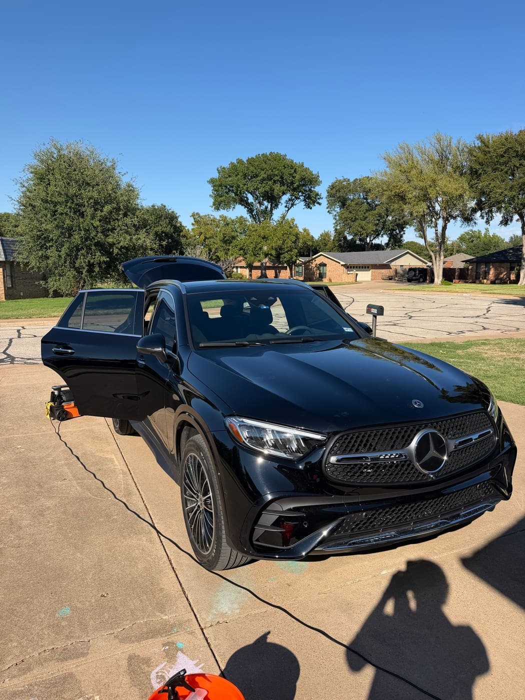 Black Mercedes-Benz GLC SUV with a glossy, freshly cleaned finish in a driveway