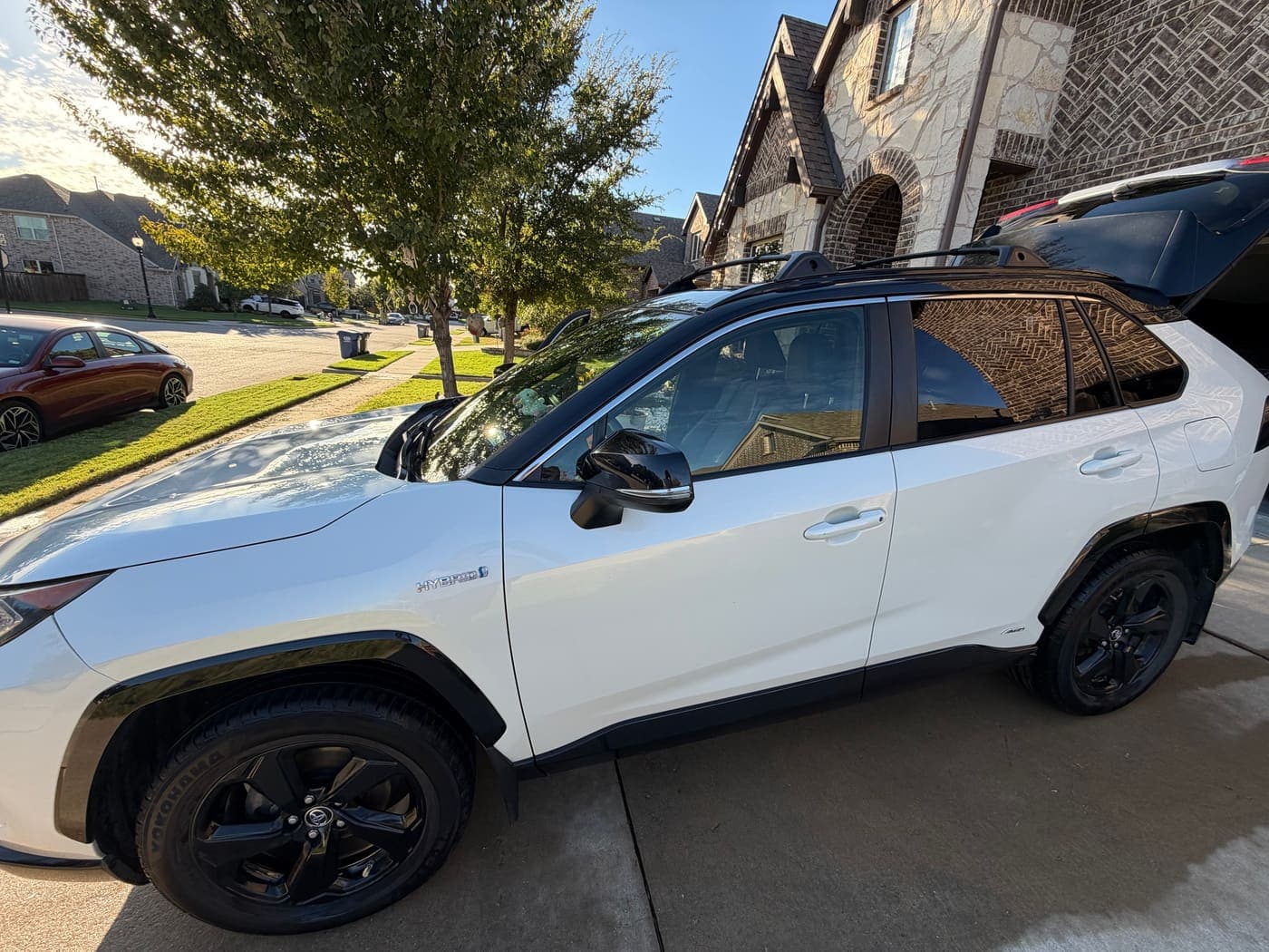 White Toyota RAV4 with black wheels after an exterior wash